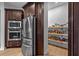 Kitchen featuring a stainless steel refrigerator and microwave combination next to the walk-in pantry at 16304 Wild Mallard Dr, Odessa, FL 33556