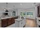 Open-concept kitchen with large island, stainless steel appliances, and lots of natural light at 16304 Wild Mallard Dr, Odessa, FL 33556