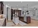 Open kitchen featuring wooden cabinets, stainless steel appliances and a large island with granite counters at 16304 Wild Mallard Dr, Odessa, FL 33556