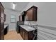 Laundry room features wooden cabinets, a granite counter, sink and washer and dryer at 16304 Wild Mallard Dr, Odessa, FL 33556