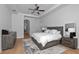 Main bedroom with wood floors, tray ceiling, and wood furnishings at 16304 Wild Mallard Dr, Odessa, FL 33556