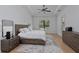 Main bedroom with wood floors, tray ceiling, and lots of natural light at 16304 Wild Mallard Dr, Odessa, FL 33556