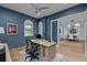 Well-lit office featuring hardwood floors, a ceiling fan, and views into the dining room at 16304 Wild Mallard Dr, Odessa, FL 33556