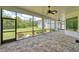 Large screened lanai with brick flooring, offering views of the lush backyard at 16304 Wild Mallard Dr, Odessa, FL 33556