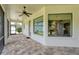 Screened-in patio with brick flooring, offering a tranquil outdoor living space at 16304 Wild Mallard Dr, Odessa, FL 33556