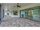 Spacious patio featuring decorative tile, ceiling fans, and sliding glass doors to bring the outside in at 16304 Wild Mallard Dr, Odessa, FL 33556