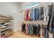 Walk-in closet with custom shelving, providing ample storage space for clothing and accessories at 16304 Wild Mallard Dr, Odessa, FL 33556