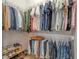 Well-organized walk-in closet with custom shelving and storage solutions for shoes, clothes and accessories at 16304 Wild Mallard Dr, Odessa, FL 33556