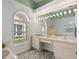 Bathroom featuring double sinks, vanity, large mirror and arched window for natural light at 1741 Elk Spring Dr, Brandon, FL 33511