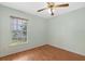 Cozy bedroom featuring laminate wood floors, and a window with blinds for privacy at 1741 Elk Spring Dr, Brandon, FL 33511