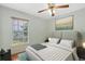 Inviting bedroom features a comfortable bed, ceiling fan, and large window with serene views at 1741 Elk Spring Dr, Brandon, FL 33511