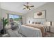 Bedroom featuring soothing decor, large window, ceiling fan, and seating area at 1741 Elk Spring Dr, Brandon, FL 33511