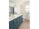 Modern bathroom with blue vanity at 2328 Harn Blvd, Clearwater, FL 33764