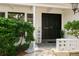 Inviting front entrance with black double doors and manicured landscaping at 2328 Harn Blvd, Clearwater, FL 33764