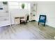 Well-lit home office with a desk, chair, and bookshelves at 2328 Harn Blvd, Clearwater, FL 33764
