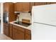 A kitchen boasts stainless steel appliances, sleek cooktop, white countertop, and wood-style cabinets at 2328 Harn Blvd, Clearwater, FL 33764