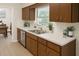 Kitchen features stainless steel appliances, white countertops, a modern faucet, and wood-style cabinets at 2328 Harn Blvd, Clearwater, FL 33764