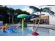 Fun splash pad pool area for small children, including palm trees, a frog slide, and water-play structures at 2328 Harn Blvd, Clearwater, FL 33764
