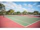 Tennis court with red and green surface, net in place, ready for a friendly match at 2328 Harn Blvd, Clearwater, FL 33764