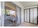 Balcony view into bedroom featuring comfortable bedroom with a queen-sized bed and a stylish rug at 2420 Winding Creek Blvd # 209, Clearwater, FL 33761