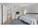 Comfortable bedroom featuring a queen bed, TV, and stylish rug on wood-look flooring at 2420 Winding Creek Blvd # 209, Clearwater, FL 33761