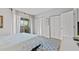 Well-lit bedroom with closets and a sliding door to a balcony overlooking lush greenery at 2420 Winding Creek Blvd # 209, Clearwater, FL 33761