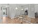 Charming dining area featuring stylish table and chairs, bright lighting, and mirrored wall at 2420 Winding Creek Blvd # 209, Clearwater, FL 33761