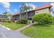 Condominium exterior view with landscaping and parking at 2420 Winding Creek Blvd # 209, Clearwater, FL 33761