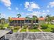 View of the condominium exterior with grassy landscaping and parking at 2420 Winding Creek Blvd # 209, Clearwater, FL 33761