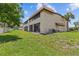 Backyard view of a charming condo building with lush green grass at 2420 Winding Creek Blvd # 209, Clearwater, FL 33761