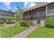 Condominium exterior with landscaping and stairs at 2420 Winding Creek Blvd # 209, Clearwater, FL 33761