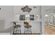 Modern kitchen featuring a breakfast bar with bar stool seating and seamless flow to the living space at 2420 Winding Creek Blvd # 209, Clearwater, FL 33761