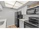 Contemporary kitchen with sleek appliances, bright lighting, and modern finishes at 2420 Winding Creek Blvd # 209, Clearwater, FL 33761
