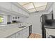 Bright kitchen featuring modern finishes, a breakfast bar, and seamless flow to the living area at 2420 Winding Creek Blvd # 209, Clearwater, FL 33761