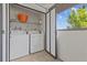 Convenient balcony laundry area with washer and dryer, offering outdoor access and natural light at 2420 Winding Creek Blvd # 209, Clearwater, FL 33761