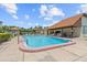 Inviting community pool with comfortable lounge chairs and a covered pavilion at 2420 Winding Creek Blvd # 209, Clearwater, FL 33761