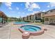 Community pool area featuring a jacuzzi, comfortable lounge chairs, and a covered pavilion at 2420 Winding Creek Blvd # 209, Clearwater, FL 33761