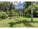 The beautifully manicured yard features a variety of trees and lush green grass at 2898 Thaxton Dr # 76, Palm Harbor, FL 34684