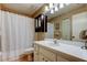 Cozy bathroom featuring a white vanity, a toilet, and a shower with a curtain for privacy at 2898 Thaxton Dr # 76, Palm Harbor, FL 34684