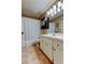 Bathroom with a white vanity, a toilet, a mirror, and a shower with a curtain for privacy at 2898 Thaxton Dr # 76, Palm Harbor, FL 34684
