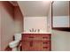 Bathroom features a wooden vanity with modern fixtures, toilet, and framed mirror at 2898 Thaxton Dr # 76, Palm Harbor, FL 34684