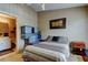 Bedroom next to bathroom with a striped bedspread, side table, and a stack of storage containers at 2898 Thaxton Dr # 76, Palm Harbor, FL 34684