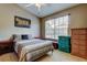 Bedroom featuring a ceiling fan, a window, a striped bedspread, and storage at 2898 Thaxton Dr # 76, Palm Harbor, FL 34684
