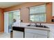 Kitchen sink and sliding glass doors lead to screened patio at 2898 Thaxton Dr # 76, Palm Harbor, FL 34684