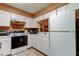 Bright kitchen features white cabinets and appliances, with plenty of countertop space at 2898 Thaxton Dr # 76, Palm Harbor, FL 34684