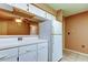 Bright kitchen features white cabinets and appliances, offering a clean and functional space at 2898 Thaxton Dr # 76, Palm Harbor, FL 34684