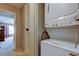Conveniently placed washer and dryer setup next to a hallway leading to a bedroom at 2898 Thaxton Dr # 76, Palm Harbor, FL 34684