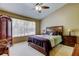 Comfortable bedroom with a ceiling fan, carpeted floor, and a large window providing natural light at 2898 Thaxton Dr # 76, Palm Harbor, FL 34684