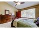 Relaxing bedroom featuring a ceiling fan, carpet, and a window allowing natural light at 2898 Thaxton Dr # 76, Palm Harbor, FL 34684