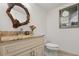 Stylish half-bathroom with granite countertop, decorative mirror, and modern fixtures at 301 2Nd N St # 14, St Petersburg, FL 33701